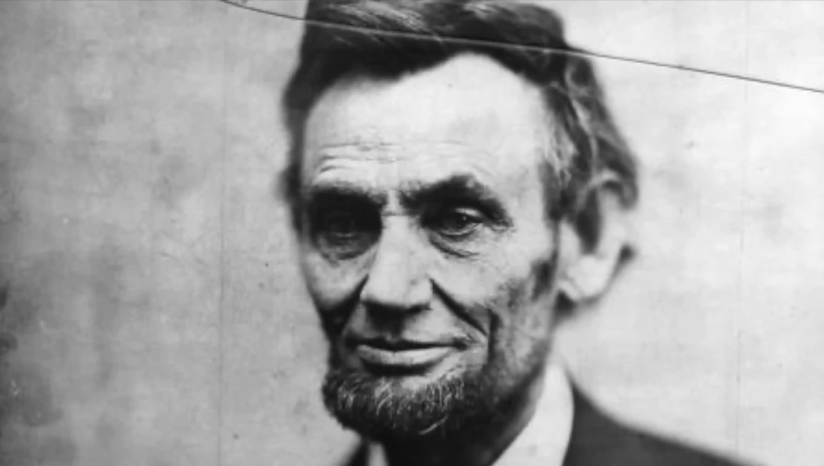 Black and white portrait photograph of a bearded man in formal attire from the 19th century.