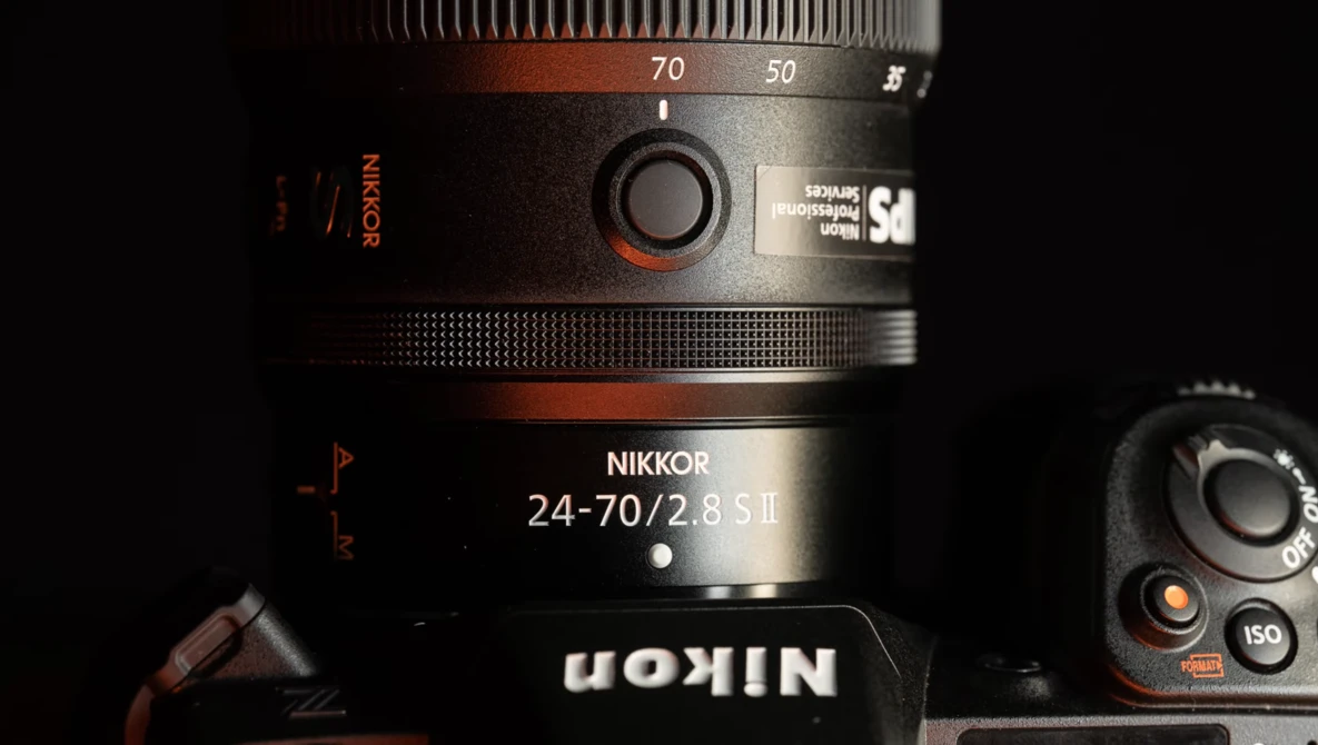 Nikkor 24-70/2.8 S II lens mounted on a camera body, showing the zoom ring and focal length markings.
