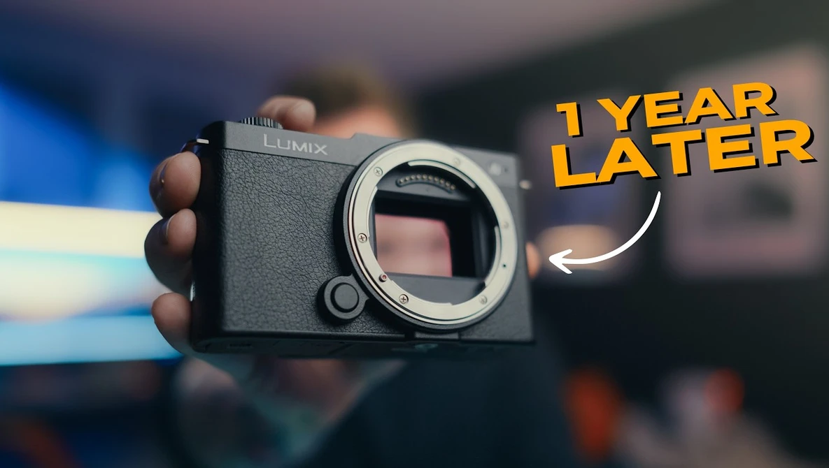 Panasonic Lumix mirrorless camera body held in hand, shown from front with lens mount exposed.
