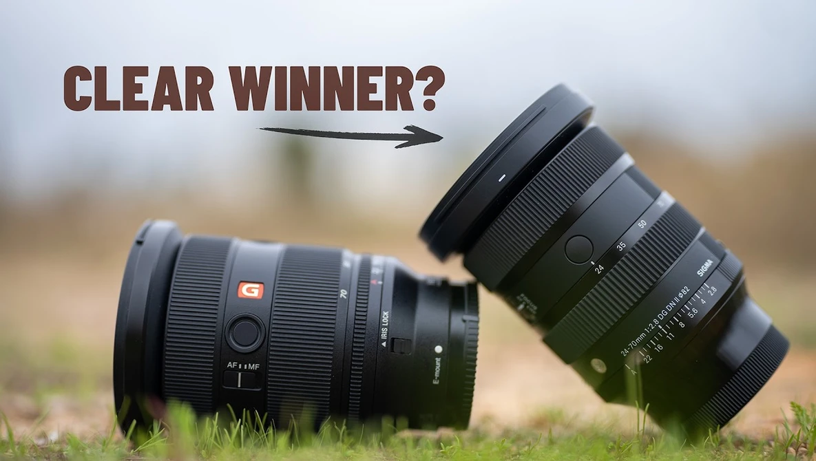 Two black camera lenses positioned on grass with text overlay asking "Clear winner?".