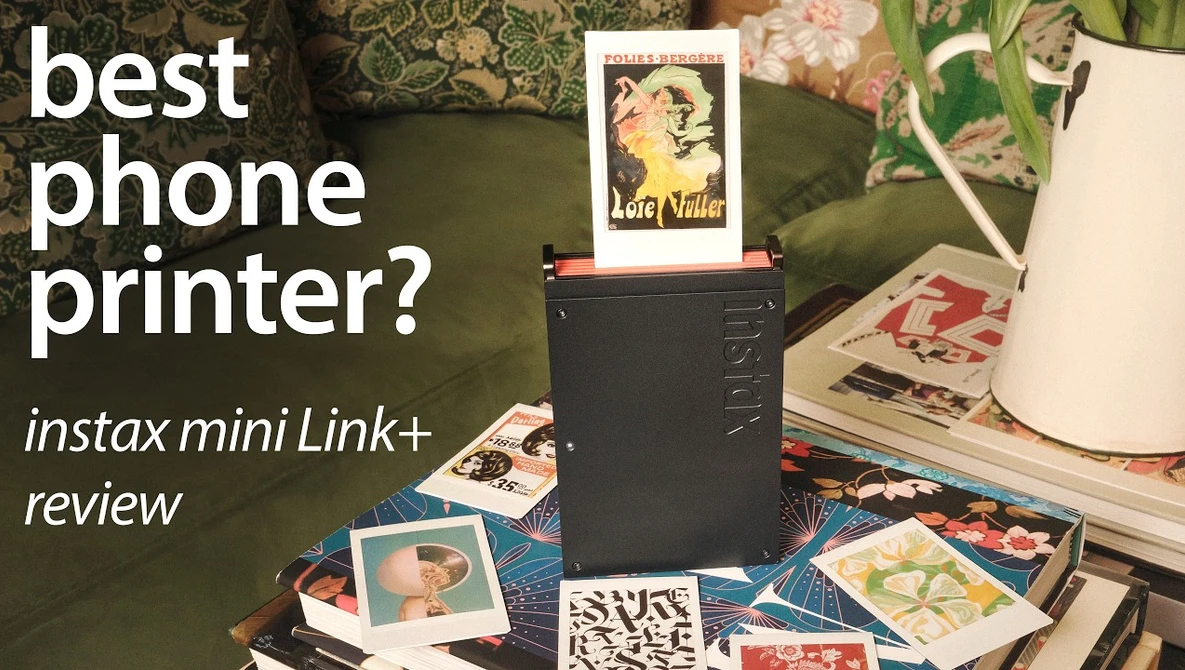 Instax Mini Link+ printer surrounded by instant photo prints on a patterned surface with floral decorations.