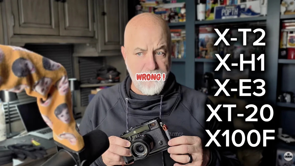 Photographer holding a vintage rangefinder camera with a list of camera models overlaid, marked "WRONG."