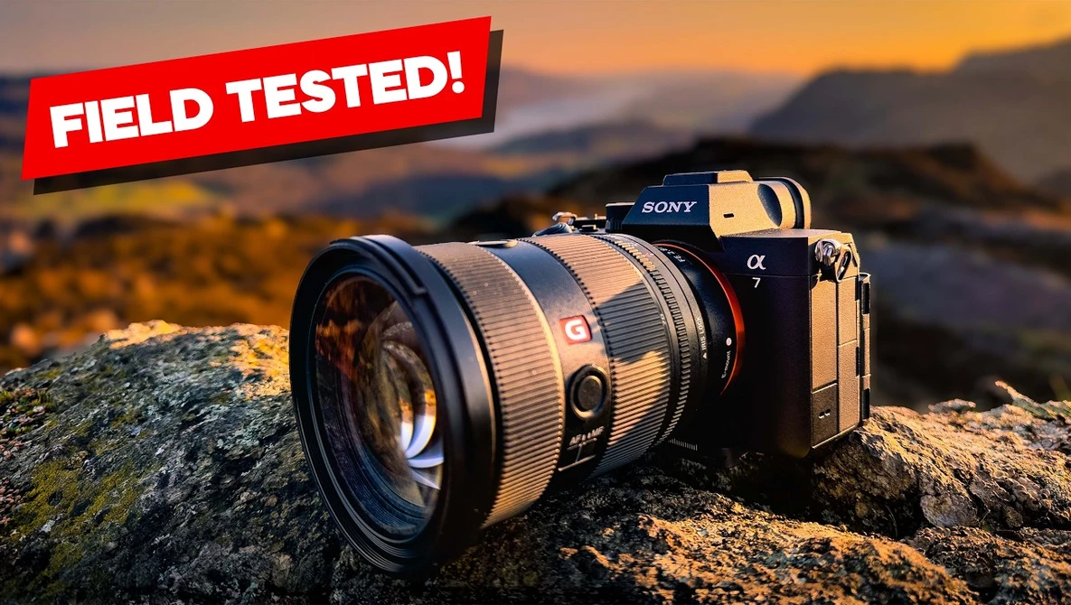 Sony Alpha mirrorless camera with telephoto lens mounted on a rocky outcrop at sunset.
