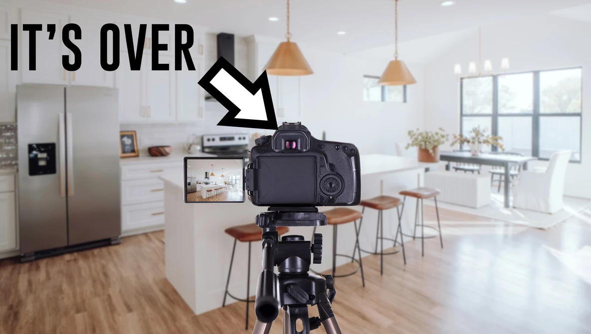 DSLR camera on tripod displaying kitchen interior on its rear screen with arrow pointing downward and 'IT'S OVER' text overlay.