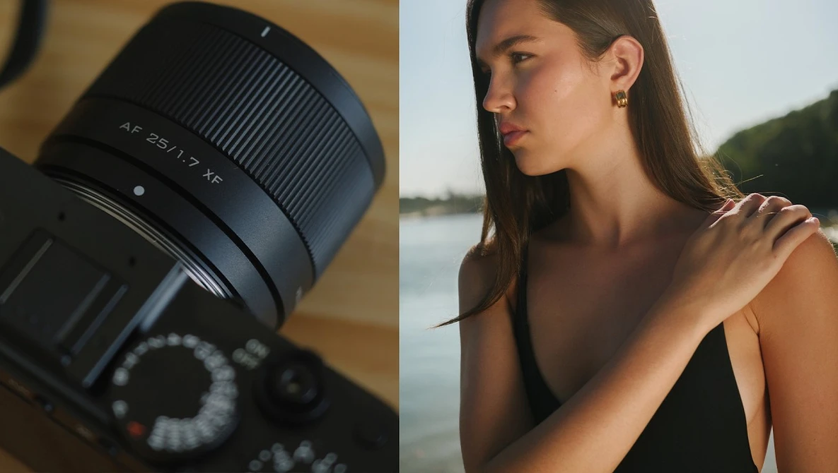 Sony lens with f/2.8 aperture mounted on camera body next to portrait of woman by water.