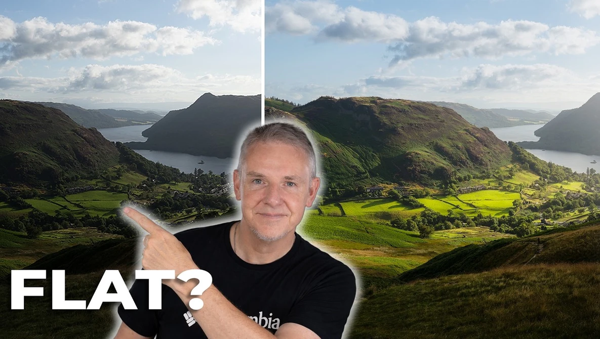 Man in black shirt pointing at mountainous valley landscape with bay and green fields.