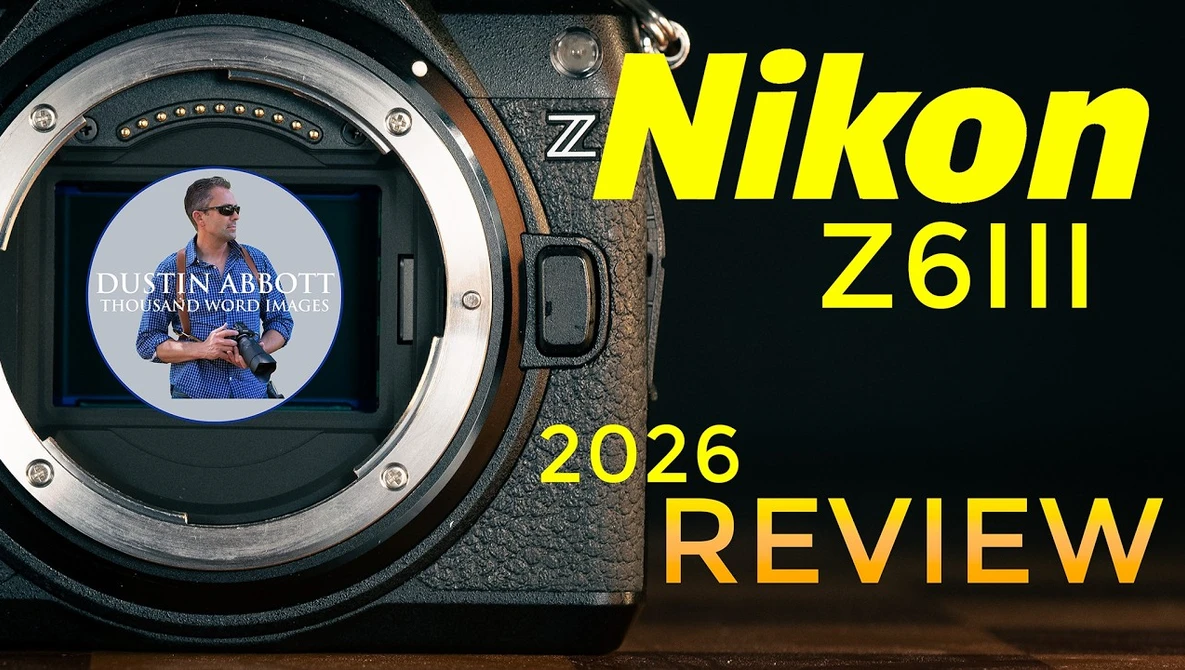 Nikon Z6III camera body with open mirror cavity and LCD screen displaying a tutorial video.