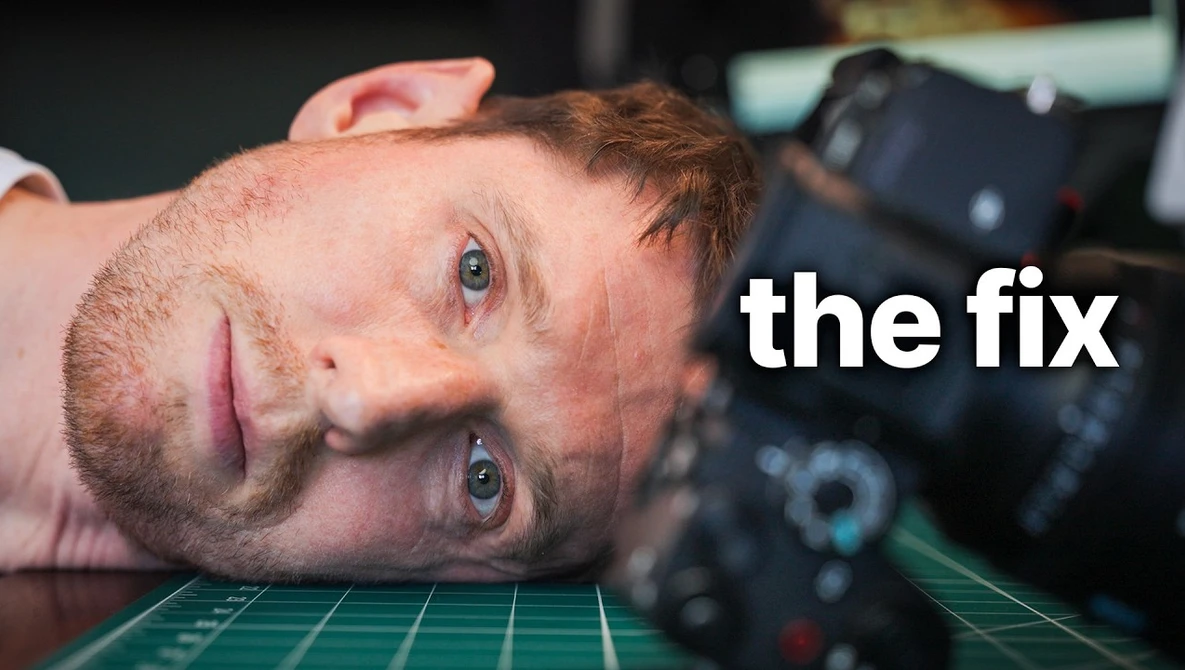 Man lying on desk with camera gear, looking at camera with tired expression labeled 'the fix.'