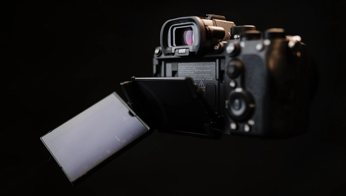Sony mirrorless camera with articulating touchscreen display tilted outward against black background