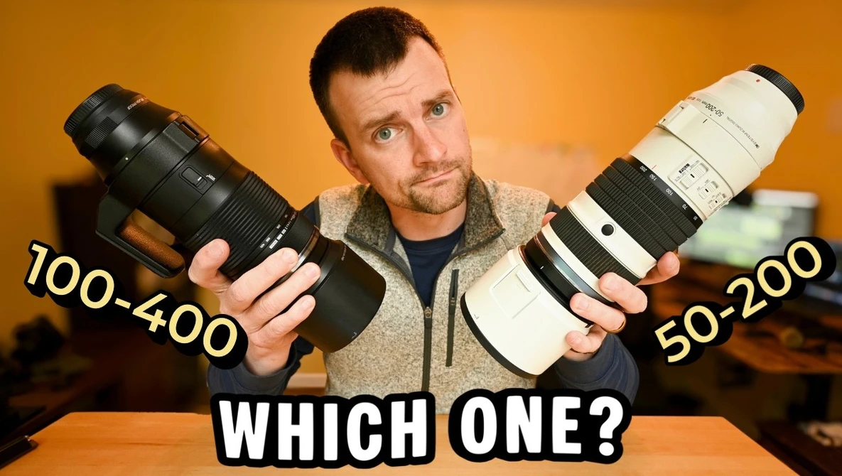 Photographer comparing two telephoto lenses labeled 100-400 and 50-200 against an orange background