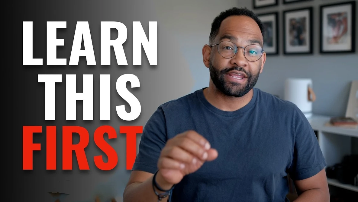 Man in glasses pointing at camera with text overlay 'LEARN THIS FIRST'