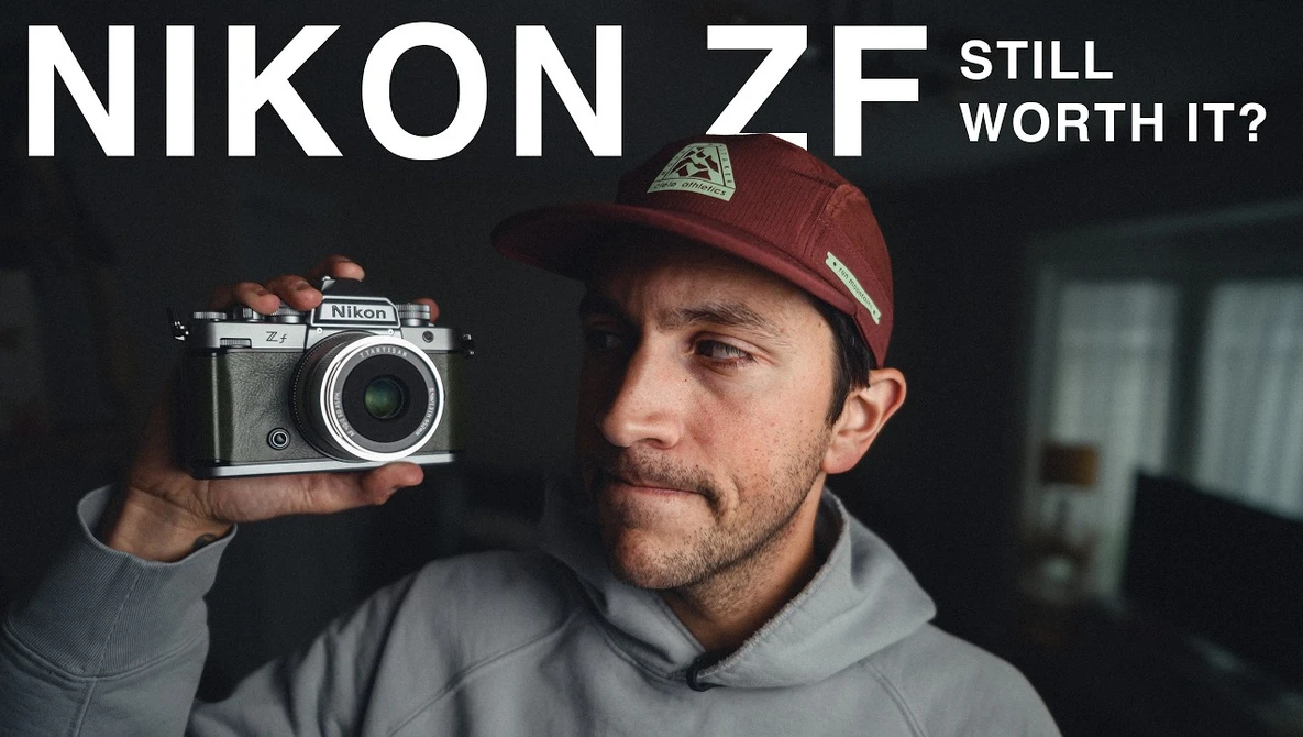 Man holding vintage Nikon ZF rangefinder camera with text overlay asking 'Still Worth It?'
