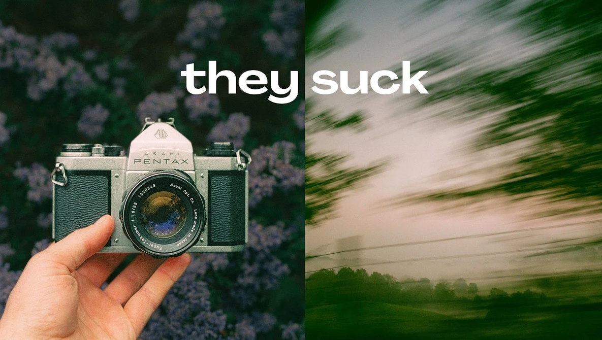 Vintage film camera held in hand next to motion-blurred landscape, with text overlay reading "they suck"