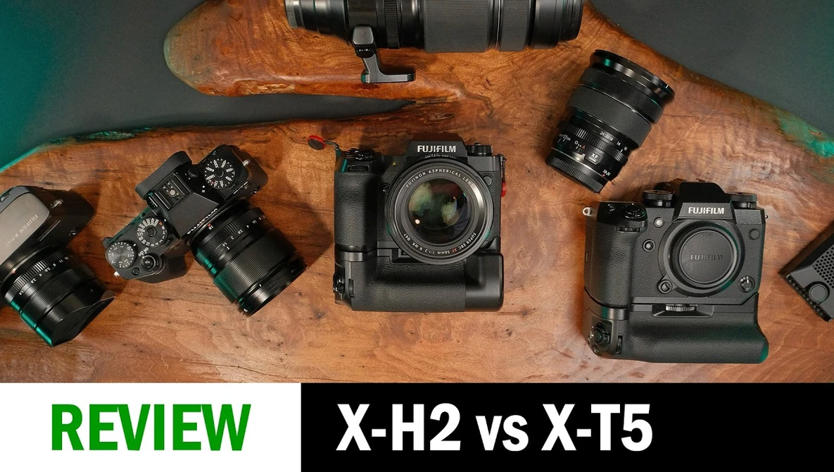 Fujifilm X-H2 and X-T5 cameras with lenses arranged on wooden surface for comparison review