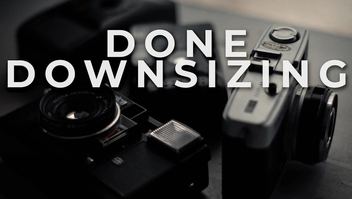 Graphic with text "DONE DOWNSIZING" overlaid on vintage cameras in black and white
