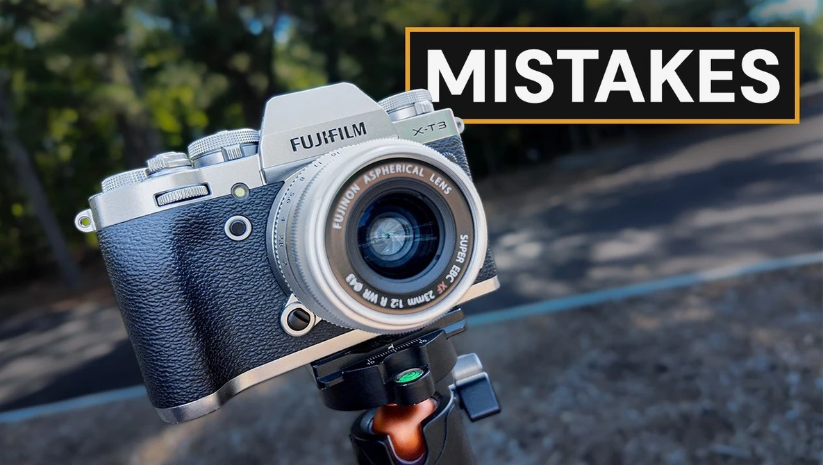 Fujifilm X-T1 camera on tripod head with yellow text overlay reading "MISTAKES"