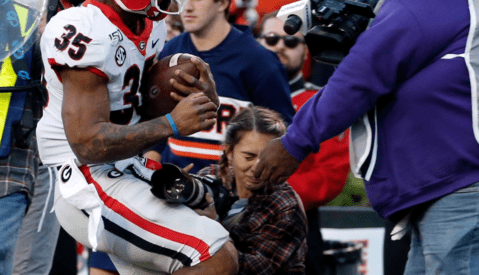 Kneeling Photographer Knocked Unconscious After Sideline Collision at Football Game