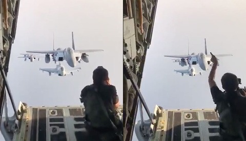 Daredevil Photographer Sits on Cargo Door to Take Pictures of Jets Flying Directly Behind Him