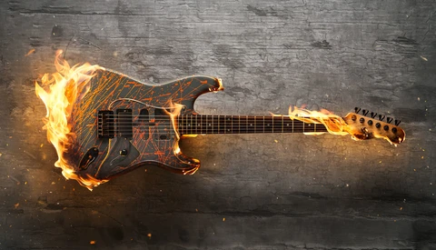 Electric guitar engulfed in flames against a dark textured background.