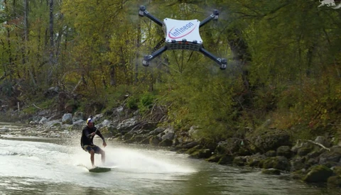Man Wakeskates Along a River Towed Only by a Drone