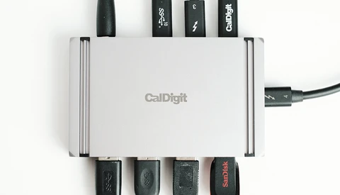 CalDigit USB hub with multiple cables connected to its ports, displaying cable management setup.