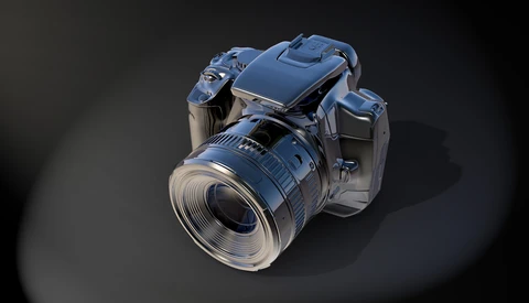 3D rendering of a digital camera with blue metallic finish and attached lens, positioned against a dark background with dramatic lighting.