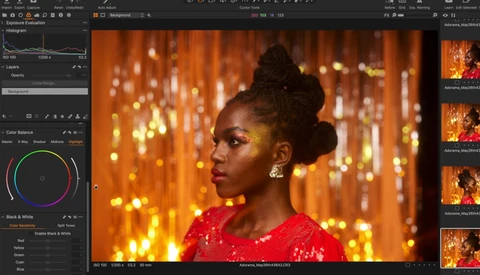 Woman in red sequined dress against warm golden bokeh background, photographed in profile with studio lighting.