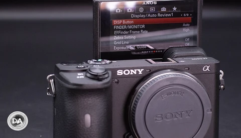 Sony Alpha mirrorless camera body displayed next to its LCD screen menu showing display and exposure settings.