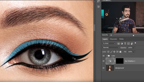 Close-up of eye makeup with bright turquoise eyeliner and winged black liner on fair skin.