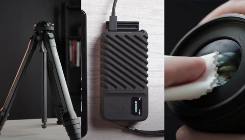 Photography equipment including a tripod, portable power bank, and lens with cleaning cloth.