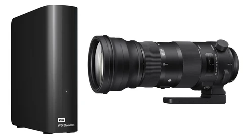 WD Elements external hard drive next to a Sigma telephoto lens on white background.