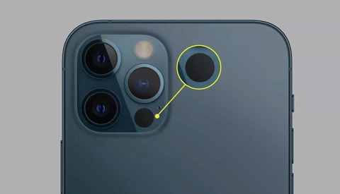 Close-up of a smartphone camera module with multiple lenses highlighted against a gray background.