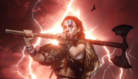 Warrior with red face paint holding an axe and staff across shoulders amid dramatic lightning and glow.