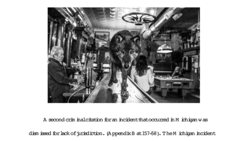Black and white photograph of people inside a narrow bar or pub, shot from behind the counter looking toward patrons.