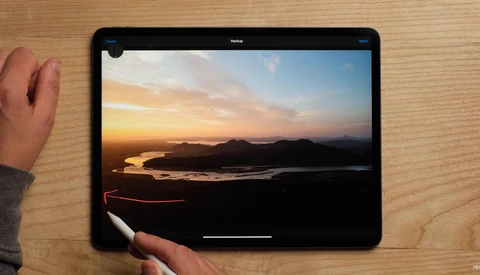 Screenshot of photo editing interface displaying a sunset landscape with golden sky reflecting on water.