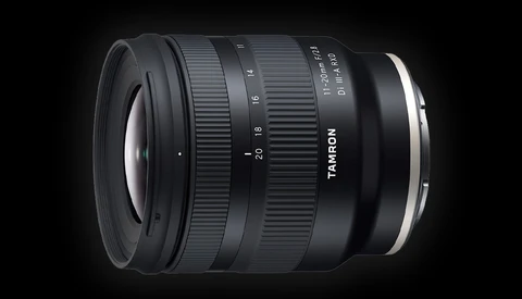 Tamron 11-20mm ultra-wide zoom lens with focus ring and aperture markings visible against dark background.
