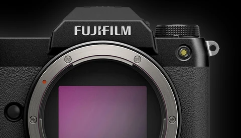 Fujifilm mirrorless camera body with exposed sensor and lens mount against dark background.
