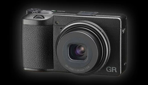 Ricoh GR compact digital camera with fixed lens displayed against dark background.