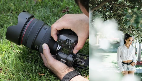 Photographer holding a mirrorless camera with wide-angle lens over grass, with portrait of woman in bright, overexposed outdoor setting displayed on right.