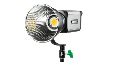Professional LED spotlight with reflector dish and yellow gimbal clamp on adjustable stand.