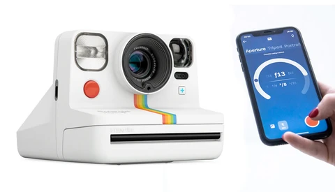 Retro-style white instant camera next to a smartphone displaying camera settings interface.