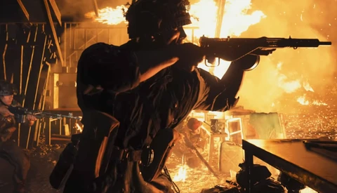 Silhouetted figure aiming rifle with dramatic golden fire and sparks illuminating the background.