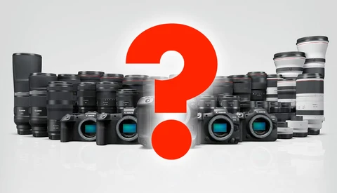 Collection of digital cameras and lenses arranged around a large red question mark.