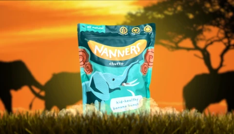 Product packaging for Nannery cherto snack displayed against an African savanna sunset backdrop with silhouetted acacia trees.