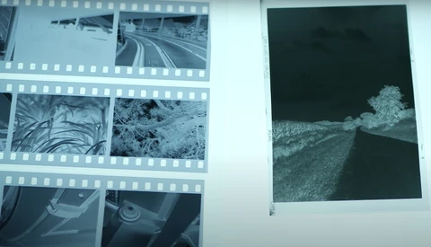 Contact sheets and prints displayed on a white surface, showing landscape photography and various film frames.