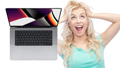 Laptop displaying colorful abstract wallpaper next to excited woman in turquoise top.