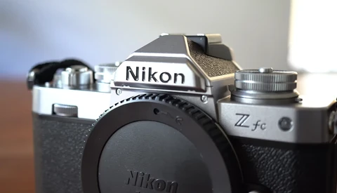 Nikon Z fc mirrorless camera body shown from above at an angle, displaying the top plate and lens mount with no lens attached.