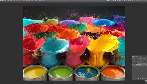Vibrant paint cans and splashing colored liquid against dark background with four paint-filled containers in foreground.