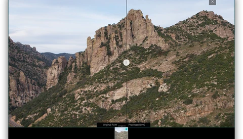 Dramatic mountain landscape with towering columnar rock formations rising from forested slopes.