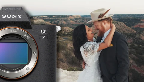 Sony Alpha 7 camera body next to couple embracing at canyon overlook.